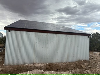 Completed metal solar shade structure beneath a cloudy northeastern Arizona sky