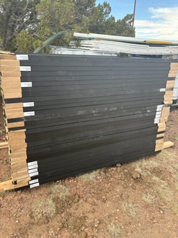 Solar panels stacked on pallets before installation at a ranch in northeastern Arizona