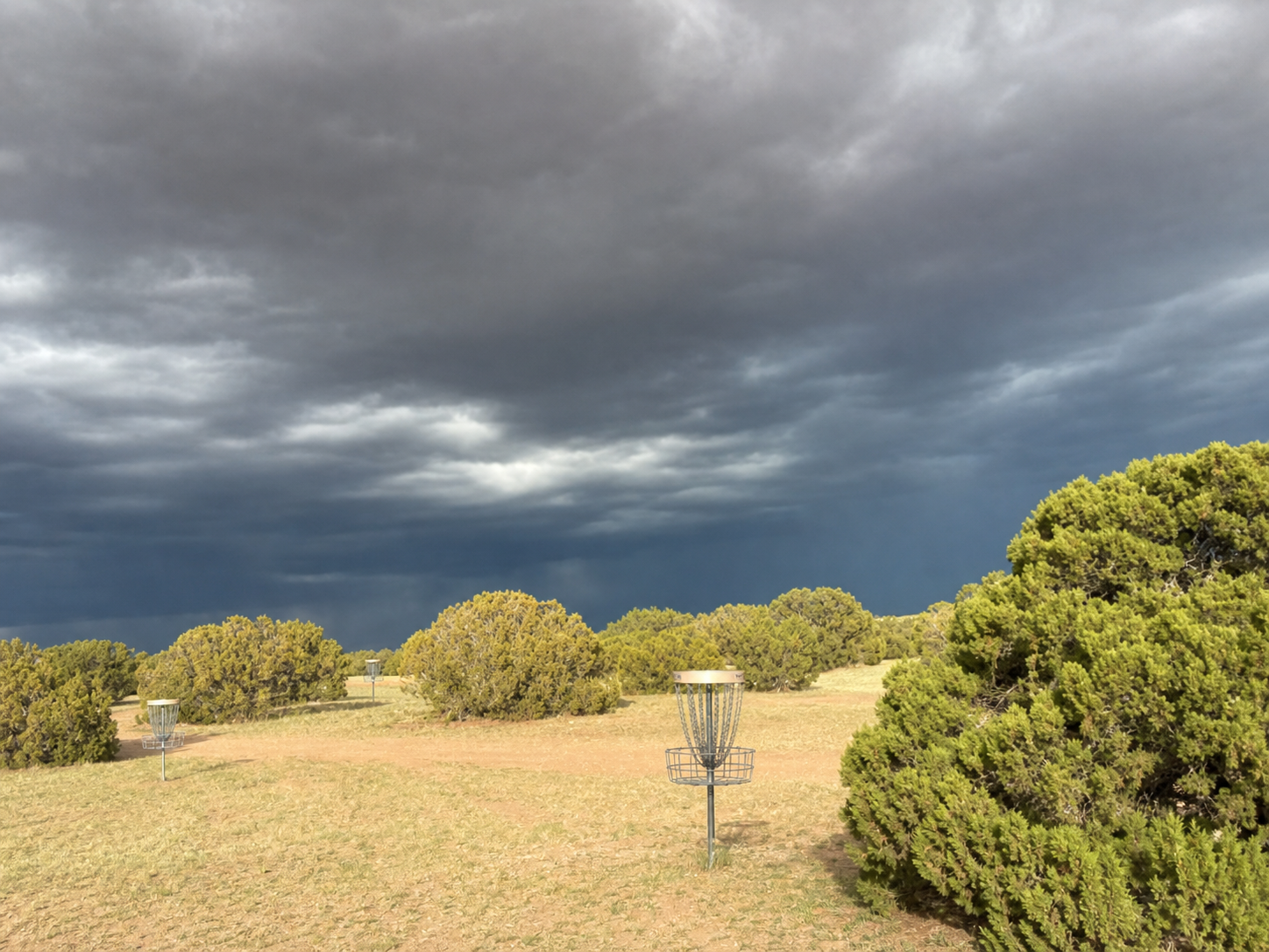 Disc-golf baskets spaced across the high-desert landscape at West End Ranch